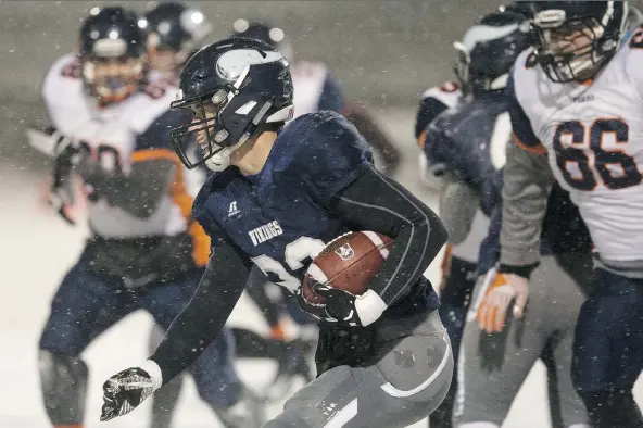  ?? KAYLE NEIS ?? J.T. Lamb of the North Battleford Vikings runs the ball during the 3A city football final at SMF Field on Friday. Lamb’s two second-half touchdowns were key in the 26-15 win.