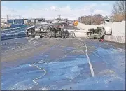  ?? AP ?? An overturned tractor-trailer rig is shown on Interstate 15 in Lehi, Utah, in this photo released by the state’s Highway Patrol. The vehicle was carrying butane, and the Highway Patrol said the interstate was closed in both directions because of a leak in the tank holding the flammable gas.