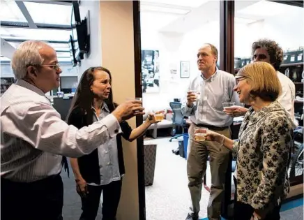 ?? NANCY STONE/CHICAGO TRIBUNE ?? Chicago Tribune columnist Mary Schmich, second from left, celebrates in the newsroom after the announceme­nt that she had won the 2012 Pulitzer Prize in the commentary category. Toasting her are then-Editor Gerould Kern, from left, then-Deputy Managing Editor Peter Kendall, then-Deputy Metro Editor Mark Jacob and then-writer Barbara Brotman.