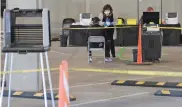  ?? ASSOCIATED PRESS FILE PHOTO ?? Election workers attend to voters at a makeshift polling station inside a parking garage on May 5 in Santa Fe.