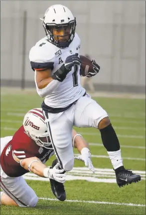  ?? Jessica Hill / Associated Press ?? UConn running back Art Thompkins gains yards as UMass linebacker Cole McCubrey reaches to tackle during the Huskies’ 5635 victory on Saturday in Amherst, Mass.