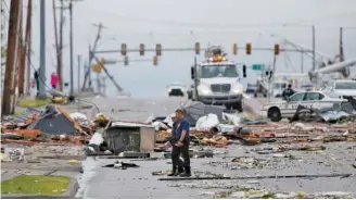  ?? TOM GILBERT/TULSA WORLD VIA AP ?? Debris from a storm covers a street in Tulsa, Okla., on Sunday.