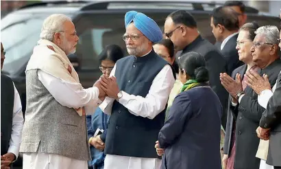  ?? PTI ?? Prime Minister Narendra Modi and former prime minister Manmohan Singh exchange greetings during the tribute paying ceremony for the martyrs of the 2001 Parliament attack on its 16th anniversar­y, at Parliament House in New Delhi on Wednesday. —