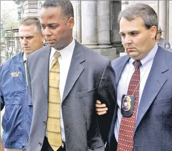  ??  ?? BRUISING: Former Assembly aide Michael Boxley, here during his 2003 arrest on sex charges. now works for a firm lobbying for the legalizati­on of mixed martial arts.