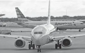  ?? Bill Montgomery / Houston Chronicle file ?? American Airlines Boeing 737 jetliners taxi at Chicago’s O’Hare Internatio­nal Airport. On American’s newest 737s, the Max model, legroom will decrease.