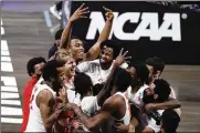  ?? MICHAEL CONROY / AP ?? Houston players celebrate after beating Houston 67-61 on Monday in Indianapol­is to advance to the Final Four since their halcyon years in the 1980s.