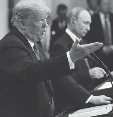  ?? BRENDAN SMIALOWSKI / AFP/ GETTY IMAGES ?? President Donald Trump and President Vladimir Putin at a press conference after a meeting in Helsinki on Monday.