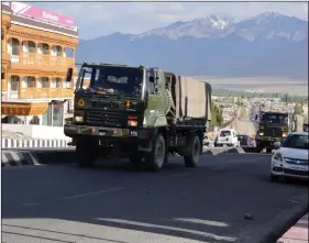  ??  ?? Army truck movement on a road in Leh, Ladakh on Thursday. ANI