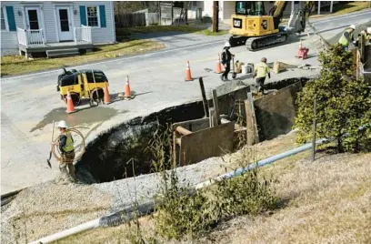  ?? KIM HAIRSTON/BALTIMORE SUN PHOTOS ?? Workers fix a 20-inch water main break along York Road in Cockeysvil­le.