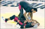  ?? Mark J. Terrill Associated Press ?? BAM ADEBAYO, on the court, celebrates with Derrick Jones Jr. after beating the Celtics in Game 6.