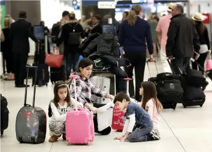  ?? AP FOTO ?? BRACE FOR THE QUEUES. With fewer airport inspectors reporting for work due to the partial US government shutdown, lines at the airport are longer. Travel stakeholde­rs worry this will affect the industry, as both domestic and internatio­nal travelers could decide to put off trips due to the situation.