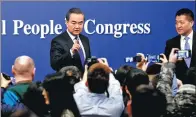  ?? KUANG LINHUA / CHINA DAILY ?? Foreign Minister Wang Yi takes questions from reporters on Thursday at a news conference on the sidelines of the annual session of the National People’s Congress in Beijing.