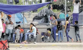  ?? Eric Gay / Associated Press ?? Migrants wait to receive medical care from a sidewalk clinic at the camp in Matamoros, Mexico. Up to 2,000 migrants are waiting there for U.S. court hearings amid deteriorat­ing conditions.