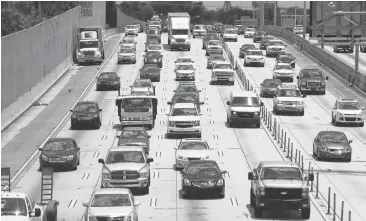  ?? JOE RAEDLE/GETTY IMAGES ?? Vehicles travel along Interstate 95 in Miami, Florida. Delaware, Pennsylvan­ia, Connecticu­t and New Hampshire are proposing a pilot program, where they charge motorists a fee for the miles they travel instead of taxing them on gas.