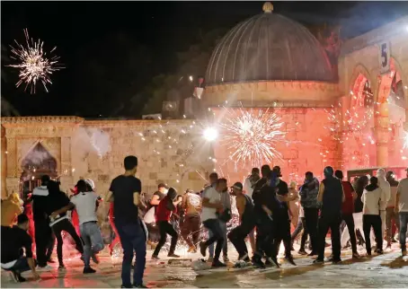  ?? AFP ?? Riot police fired stun grenades at Palestinia­ns inside Al-Aqsa Mosque, where throngs of worshipper­s were praying on the last Friday of Ramadan.