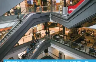  ?? ?? BUENOS AIRES: People use escalators in a shopping mall in Buenos Aires on April 12, 2024. — AFP