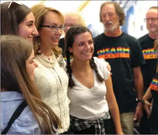  ?? Courtesy photo ?? Gabrielle Giffords, third from the left, takes a picture while speaking to Katie Hill’s supporters at her Stevenson Ranch headquarte­rs. Giffords is a former congresswo­man from Arizona.