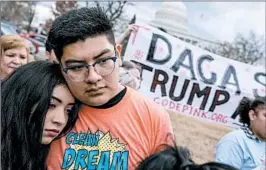  ?? ANDREW HARNIK/AP ?? Immigratio­n advocates rally last month in Washington, D.C. On Monday, the Supreme Court kept alive a ruling that shields some young immigrants from deportatio­n.