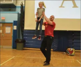  ?? PHOTO PROVIDED ?? Former profession­al mixed martial arts fighter Tom Murphy lifts a student at Goff Middle School during his anti-bullying presentati­on Tuesday.