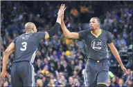  ?? AP ?? Golden State's Kevin Durant high-fives teammate David West after scoring during the second half of their NBA game against the New Orleans Pelicans on Saturday. The Warriors won 123-101.