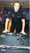  ?? JIM WELLS/ POSTMEDIA ?? Police Staff Sgt Mark Hatchette shows seized firearms and ammunition.