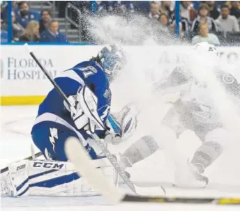  ?? Chris O’Meara, The Associated Press ?? Tampa Bay Lightning goaltender Peter Budaj gets “snowed” while making a save on a shot by the Avalanche during the first period of Thursday night’s game.