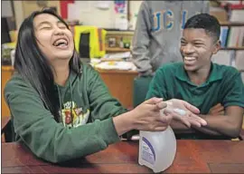  ??  ?? BLESS PATAWARAN, left, and Cody Holmes, both 13, record a safety video on hand-washing. Schools may use online lessons if they are forced to shut down.