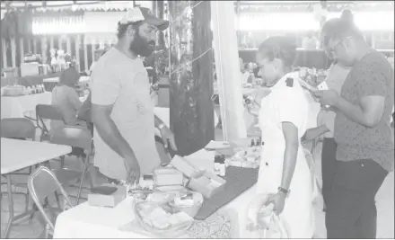  ??  ?? These patrons were yesterday considerin­g gift items for their mothers, at the Food for the Poor’s ‘Mother’s Mega Market Day’ at the Umana Yana in Kingston. The event was hosted as a fundraiser and gave patrons the opportunit­y to pick out a gift for Mother’s Day. (Terrence Thompson Photo)