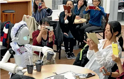  ?? WASHINGTON POST ?? A robot serves drinks at a cafe in Tokyo where avatar robots are operated by staff with severe physical disabiliti­es.