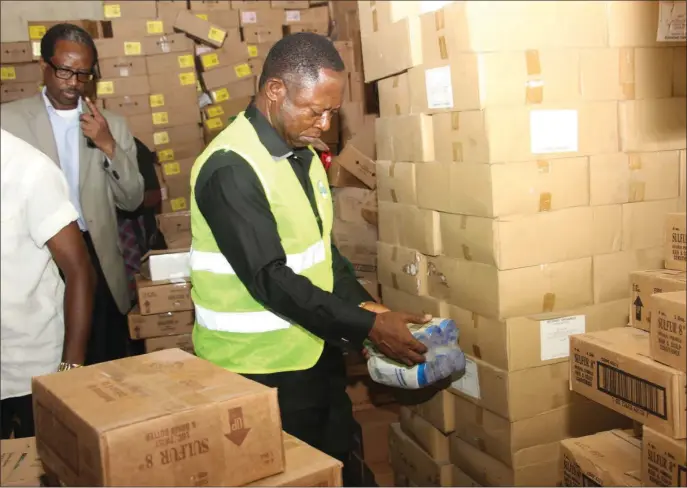  ??  ?? Obayi inspecting some of the expired items in Lagos