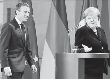  ?? MICHAEL SOHN THE ASSOCIATED PRESS ?? German Chancellor Angela Merkel, right, and France’s President Emmanuel Macron arrive for a joint statement prior to a meeting at the chanceller­y in Berlin in November. Macron favours a joint eurozone budget, while Merkel opposes it.