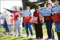  ?? Ned Gerard / Hearst Connecticu­t Media ?? Teachers, parents and students wave to passing drivers during a rally outside Town Hall in Stratford on Monday.