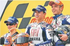  ??  ?? Lorenzo (centre) celebrates with Dani Pedrosa (left) and Italy’s Valentino Rossi.