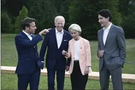  ?? Garmisch-Partenkirc­hen, Germany. BRENDAN SMIALOWSKI — POOL PHOTO ?? From left, French President Emmanuel Macron, US President Joe Biden, European Commission President Ursula von der Leyen and Canadian Prime Minister Justin Trudeau leave after posing for a group photo Sunday during the G7Summit at Castle Elmau in Kruen, near