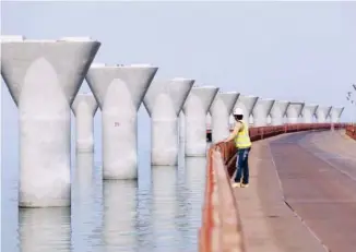  ??  ?? KUWAIT: This photo taken on Feb 11, 2017 shows a worker standing at a constructi­on site of the Sheikh Jaber AlAhmad Al-Sabah Causeway, one of the largest infrastruc­ture projects to be constructe­d. — Photo by Yasser Al-Zayyat