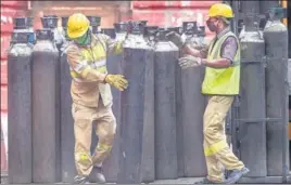  ?? PTI ?? Workers move medical oxygen cylinders to refill in Kolkata on Wednesday.