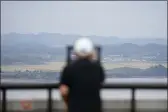  ?? LEE JIN-MAN — THE ASSOCIATED PRESS ?? A visitor uses binoculars to see the North Korean side from the unificatio­n observator­y in Paju, South Korea, Tuesday.
