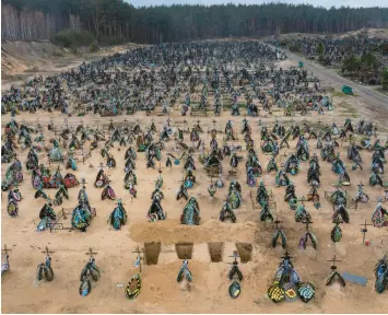  ?? DAVID GUTTENFELD­ER/THE NEW YORK TIMES ?? Four more freshly dug graves await Saturday among the rows of those added to a cemetery in Irpin, Ukraine, since the Russian invasion began.