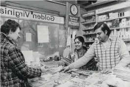  ??  ?? Determined to build new lives, many Ugandan Asians went into business. Here, shopkeeper Jagbash Patel serves a customer at his newsagents in Billericay in 1976