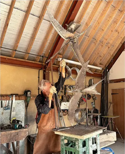  ?? ?? Hamish Mackie working on his swifts sculpture for the new Dyson Cancer Centre at the RUH in Bath