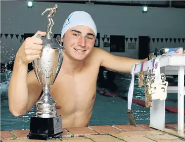  ?? Picture: FREDLIN ADRIAAN ?? CHAMP STYLE: Port Elizabeth swimmer Cameron Casali, 16, shows the 10 medals and the Victor Ludorum trophy which he was awarded recently at the Cana Zone Africa Swimming Region Games in Namibia