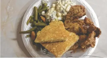  ?? PHOTO BY LYNDA EDWARDS ?? Kookie’s Famous Fried Chicken deserves its fame for the light crispy crust and juicy bird. It’s served here with sides of green beans and potato salad, plus cornbread.