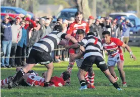  ?? PHOTO: SI LEEDS ?? Battering ram . . . Clutha’s Rym Geary gets hit with a double tackle but still manages to push his way through the Crescent defence during a South Otago premier match last month.