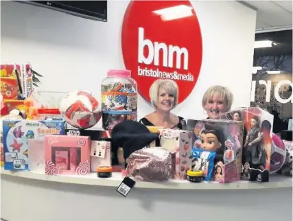  ?? HEATHER PICKSTOCK ?? Bristol Post reception staff Trina Williams and Julie Rigg with the presents purchased with money from a cake sale at the Bristol Post office