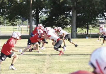  ??  ?? Harding Academy’s offensive and defensive lines battle it out in a summertime scrimmage.