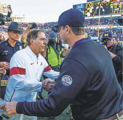  ?? MICKEY WELSH/USA TODAY NETWORK ?? Jim Harbaugh, right, and Nick Saban last met as foes in the 2020 Citrus Bowl, an Alabama win.