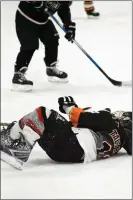  ?? JEANS PINEDA/Taos News ?? LEFT: Roman Brown, foreground, wins possession of the puck on Saturday (Feb. 4). RIGHT: Roman Brown is tripped up by the opposition in Santa Fe’s Genoveva Chavez Community Center.