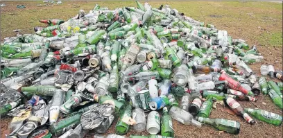  ?? Picture : ALAN EASON ?? TAKING IT ALL IN: Empty beer bottles and cans lie piled up at Marina Glen after the New Year’s weekend celebratio­ns