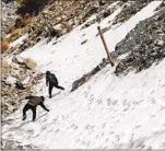  ?? Robert Gauthier Los Angeles Times ?? HIKERS navigate a drainage culvert on Mt. Baldy in February 2023.