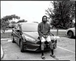  ?? ?? Kareem, in Orlando, Florida, sits on a car as his story is documented by Nomadic Photo Ark’s Monica Jane Frisell, photograph­er, and Adam Scher, editor.